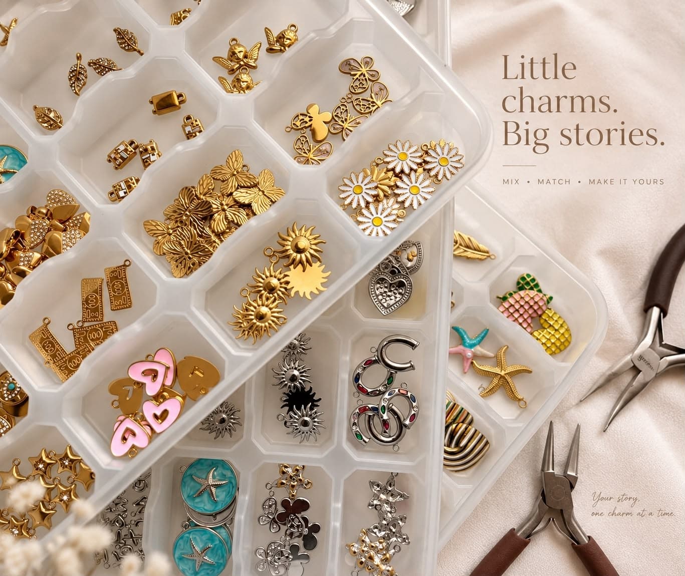 Charms sorted by design in a studio tray